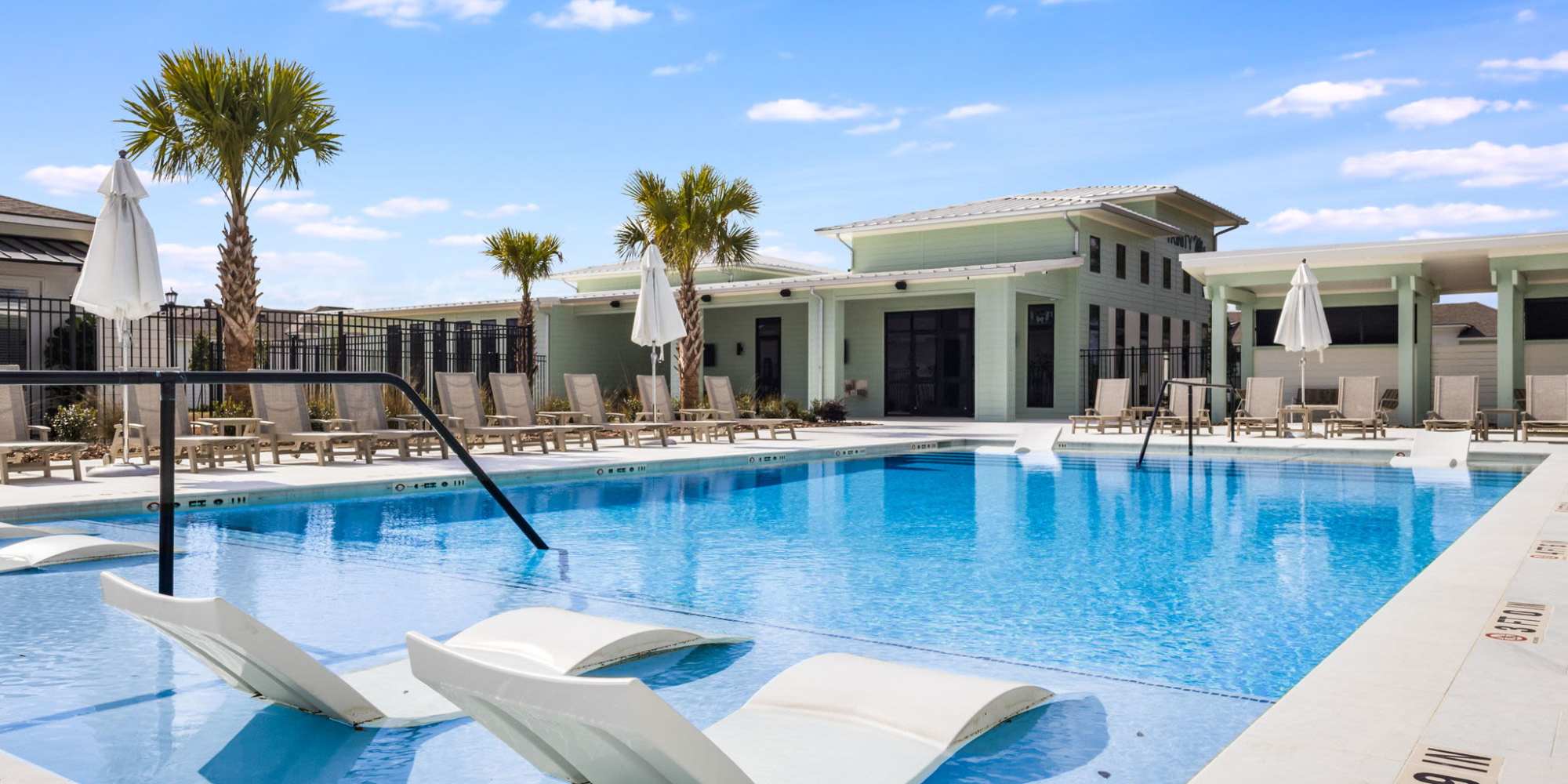 Modern swimming pool with trees all around at Lakewood Villas in Bossier City, Louisiana