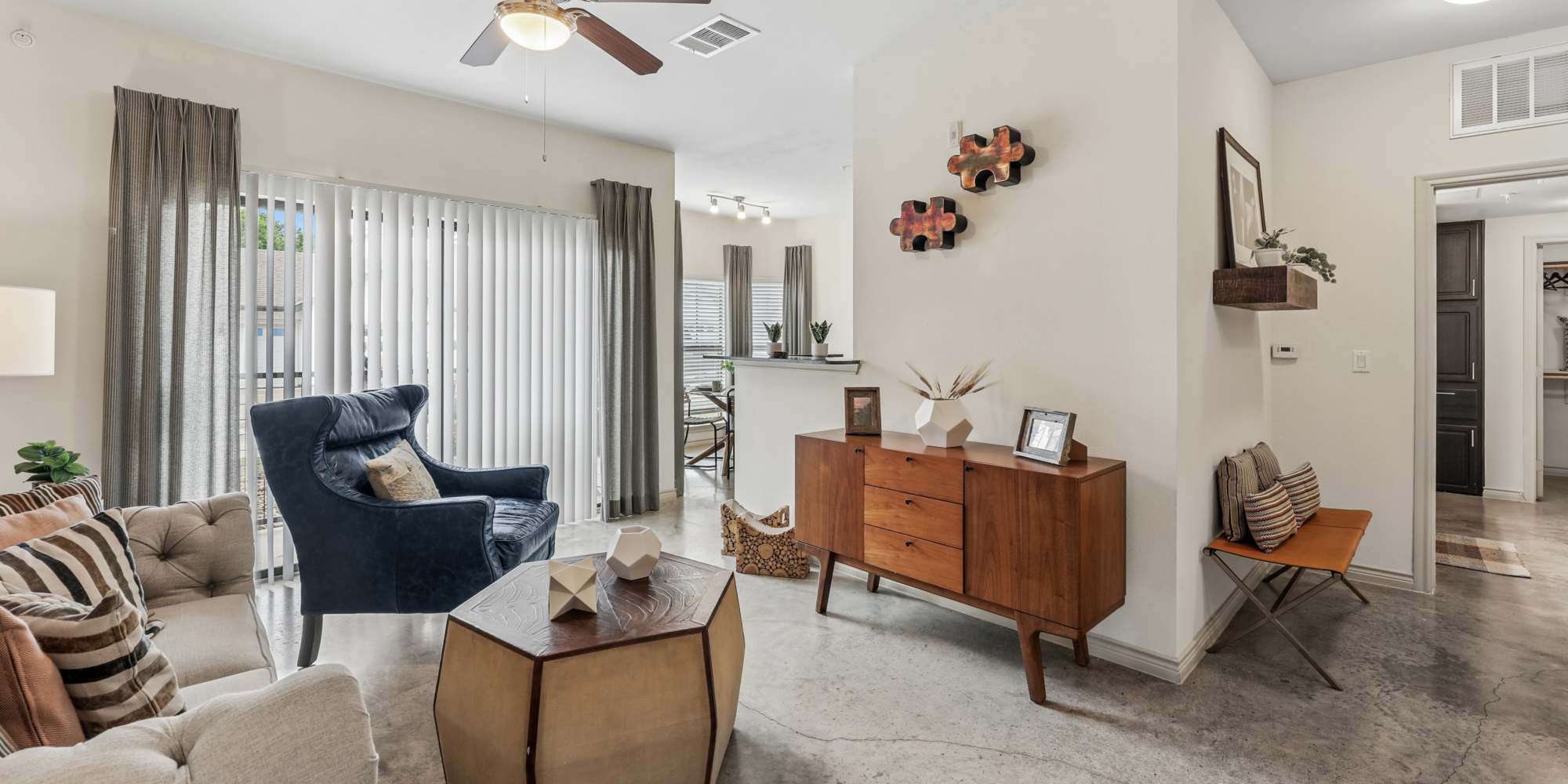 staged living room with carpeted flooring and a ceiling fan