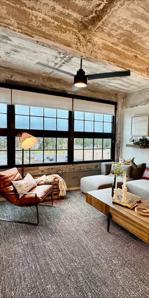 Woman painting in her home with her cat looking on at Union Terminal Warehouse in Jacksonville, Florida