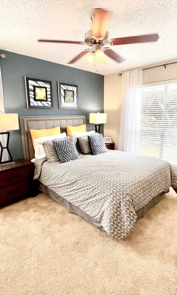 Bedroom with ceiling fan at The Abbey at Medical Center in San Antonio, Texas