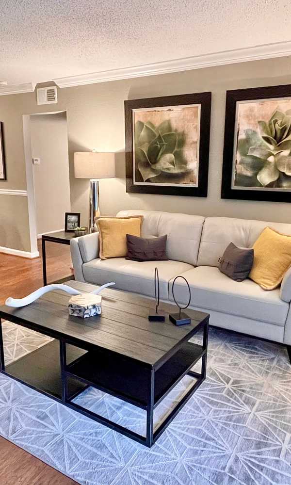Living room with designer hardwood-style floors at The Abbey at Riverchase in Hoover, Alabama