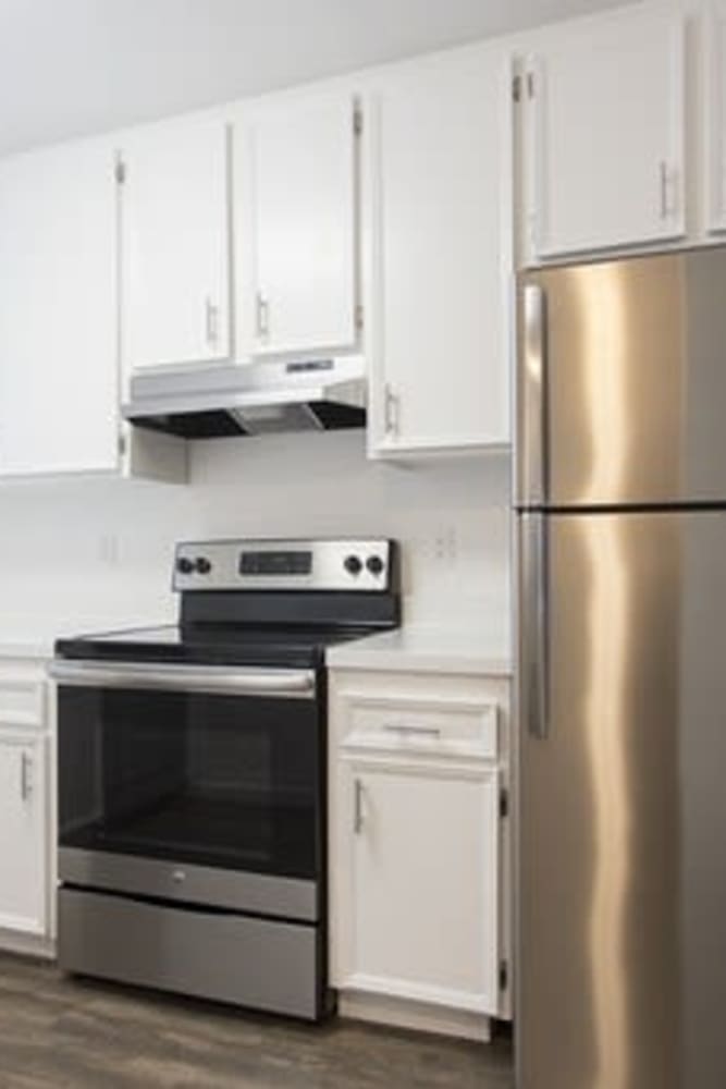 Kitchen with stainless-steel appliances at Park Place Apartments in Del Mar, California