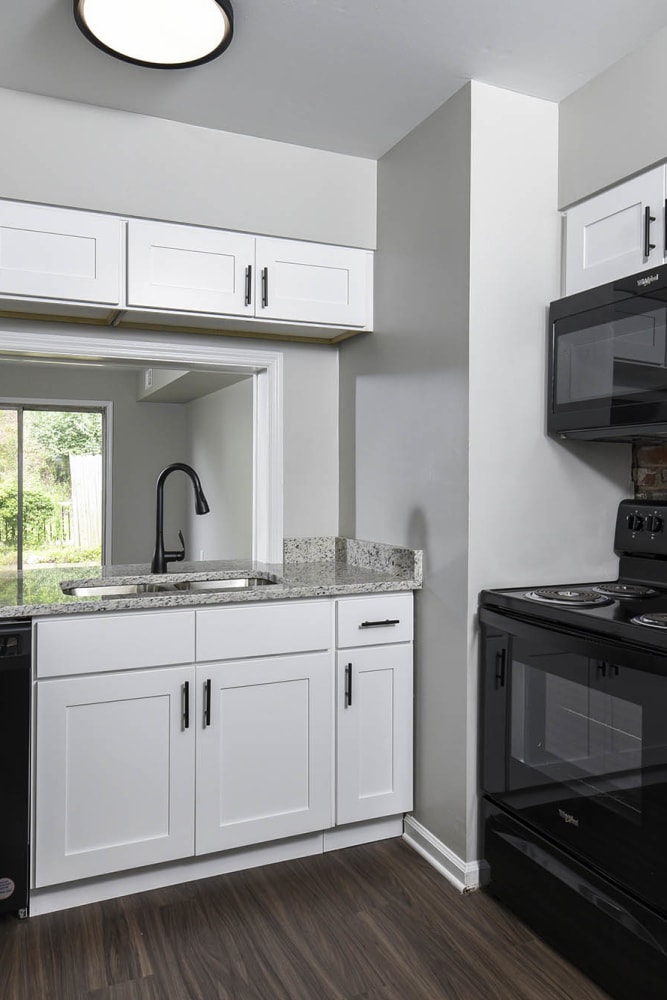 Model kitchen with wood style flooring at River Oaks in Pittsburgh, Pennsylvania