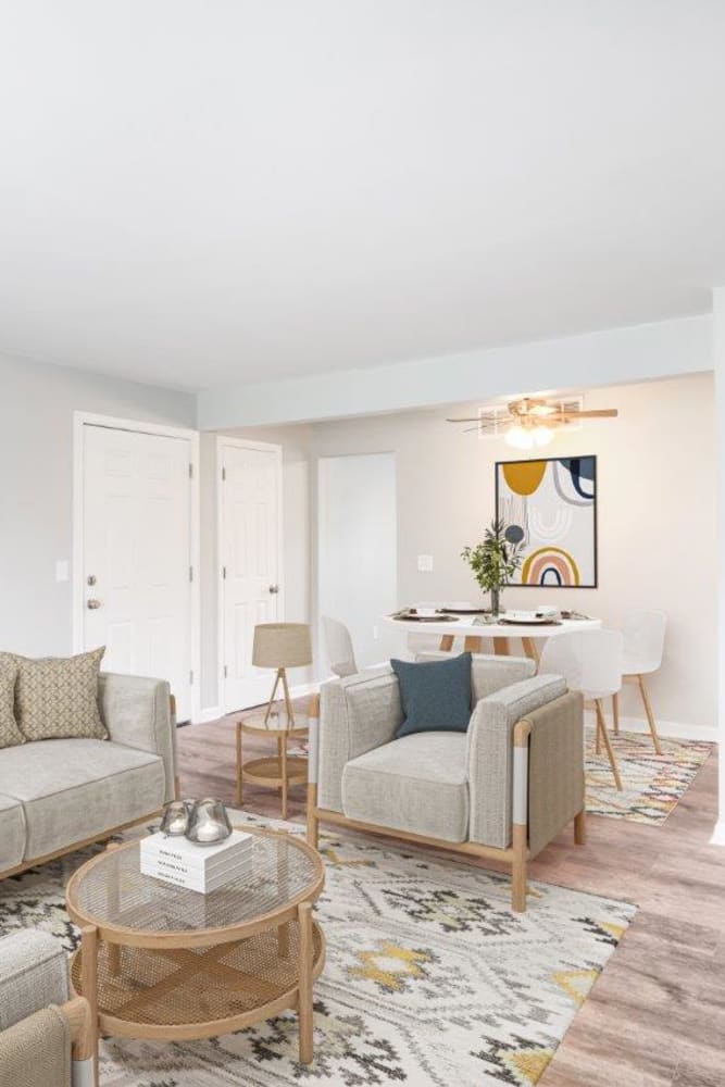 Spacious living room with couch and Dinning Area at Woodcrest Apartment Homes in Dover, Delaware