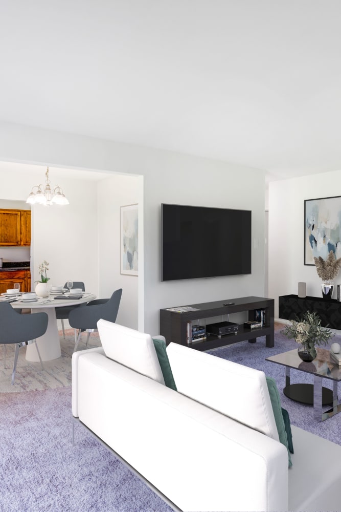Model living room with wall-to-wall carpeting at Lumberton Apartment Homes in Lumberton, New Jersey