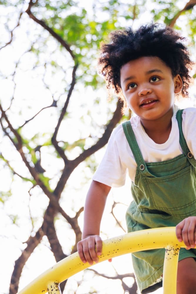 Kid on the playground at Del Corazon Apartments in Santa Rosa, California