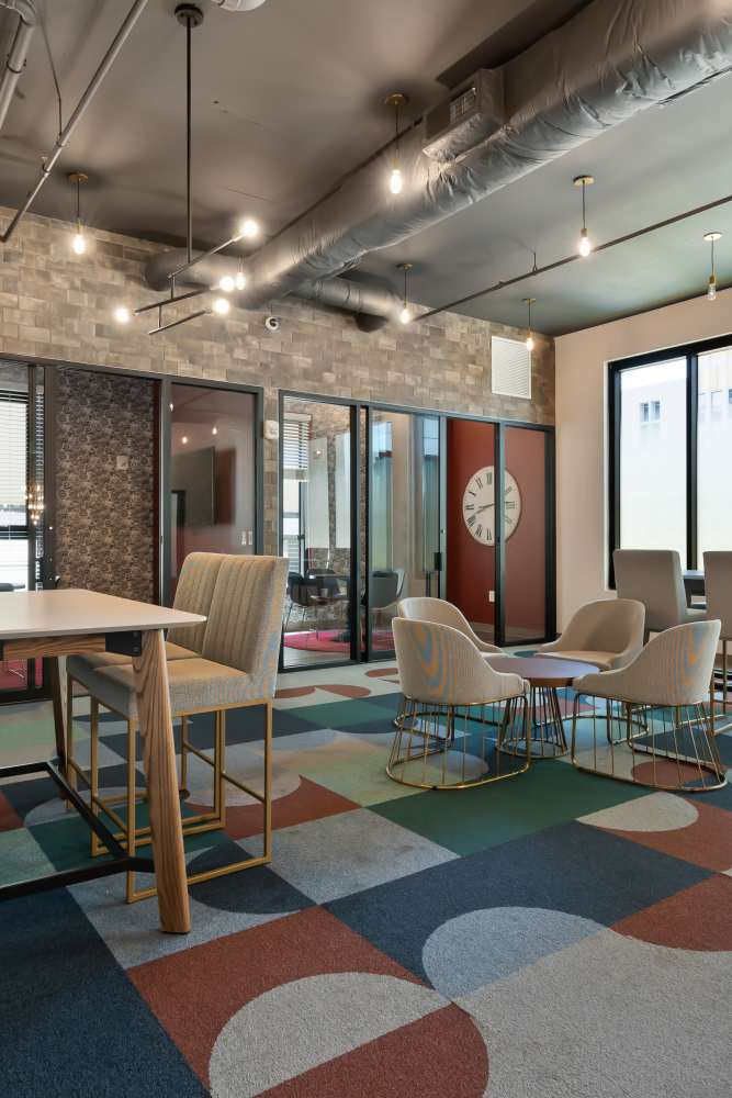 Seating area with multiple chairs and tables atSteelhaven Birmingham in Birmingham, Alabama
