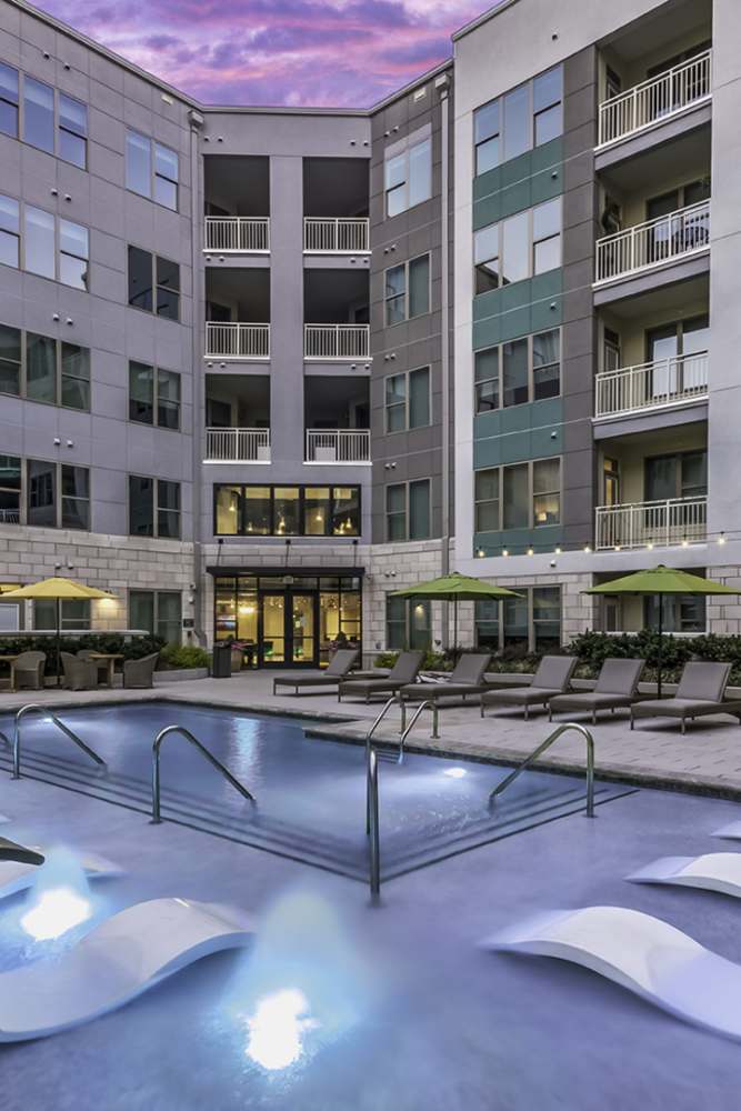 Resort-style swimming pool with lounge chairs at Greenside in Charlotte, North Carolina