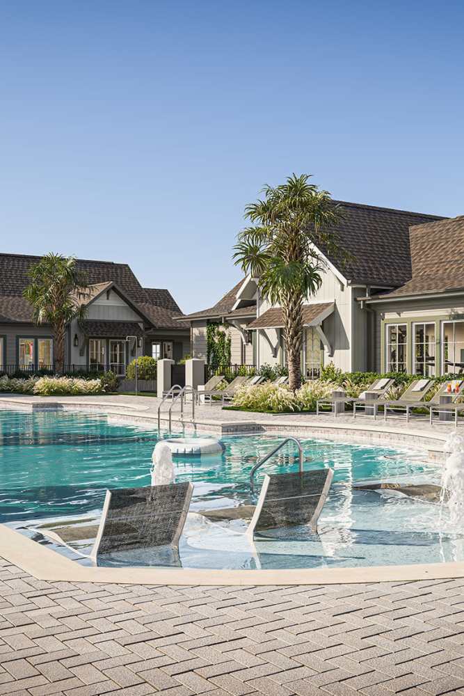 Resident walking near a pool at Pomona Apartments in Ocala, Florida