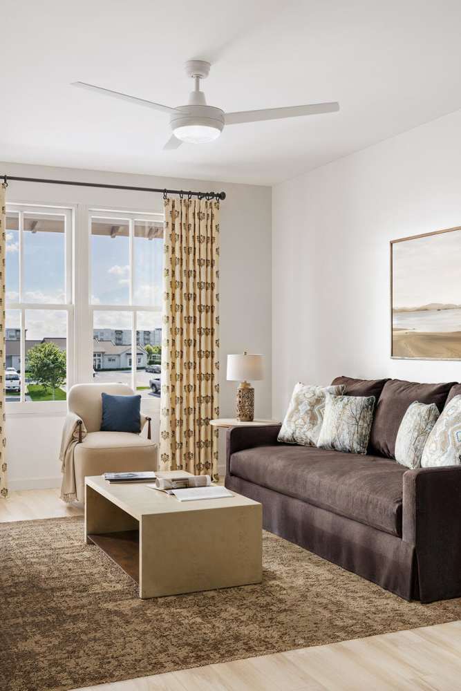 Cozy living room with sofa and natural light at Romero Apartments in Pensacola, Florida