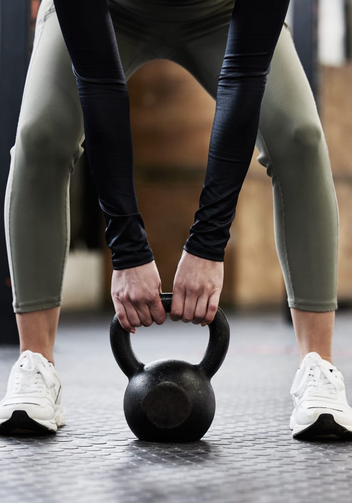 A woman holding a dumbell at Stonecreek Club in Germantown, Maryland