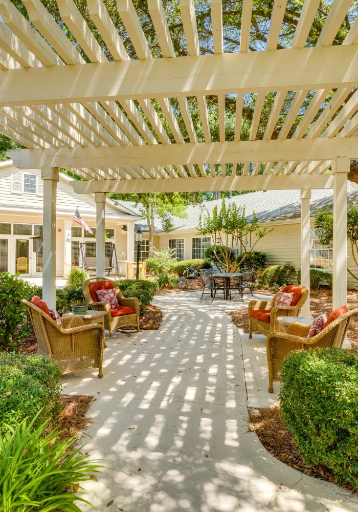 Outdoor seating along a pathway at Village Cove Assisted Living in Hilton Head Island, South Carolina