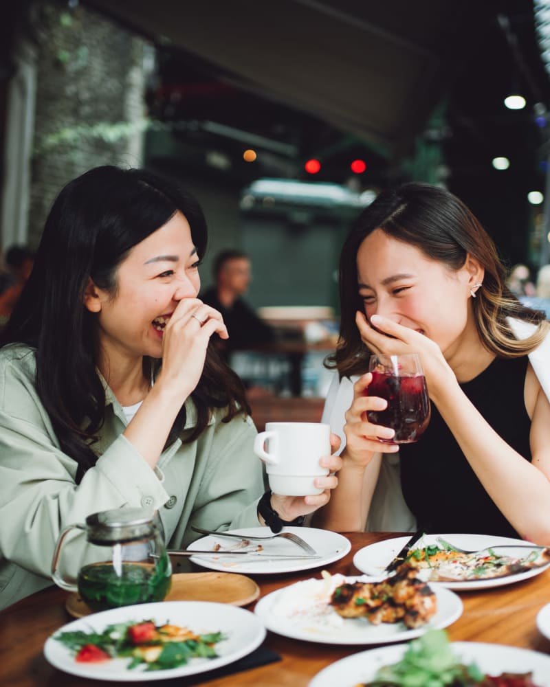 Two women enjoying a meal together near Integra Heights in Clermont, Florida