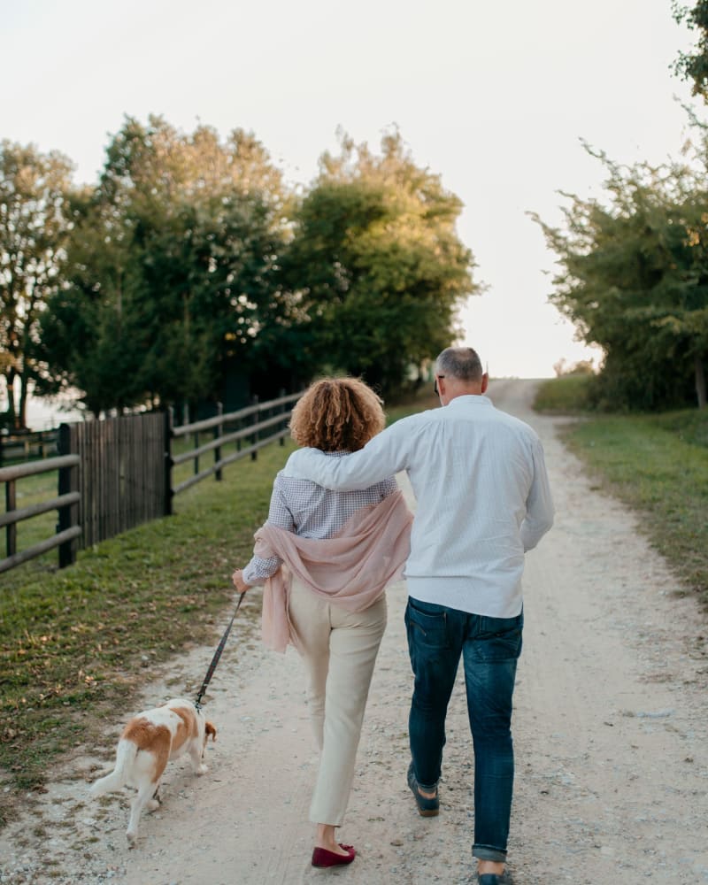 Happy couple with their dog enjoying the day outside at Noble on the Lake in Brighton, Michigan