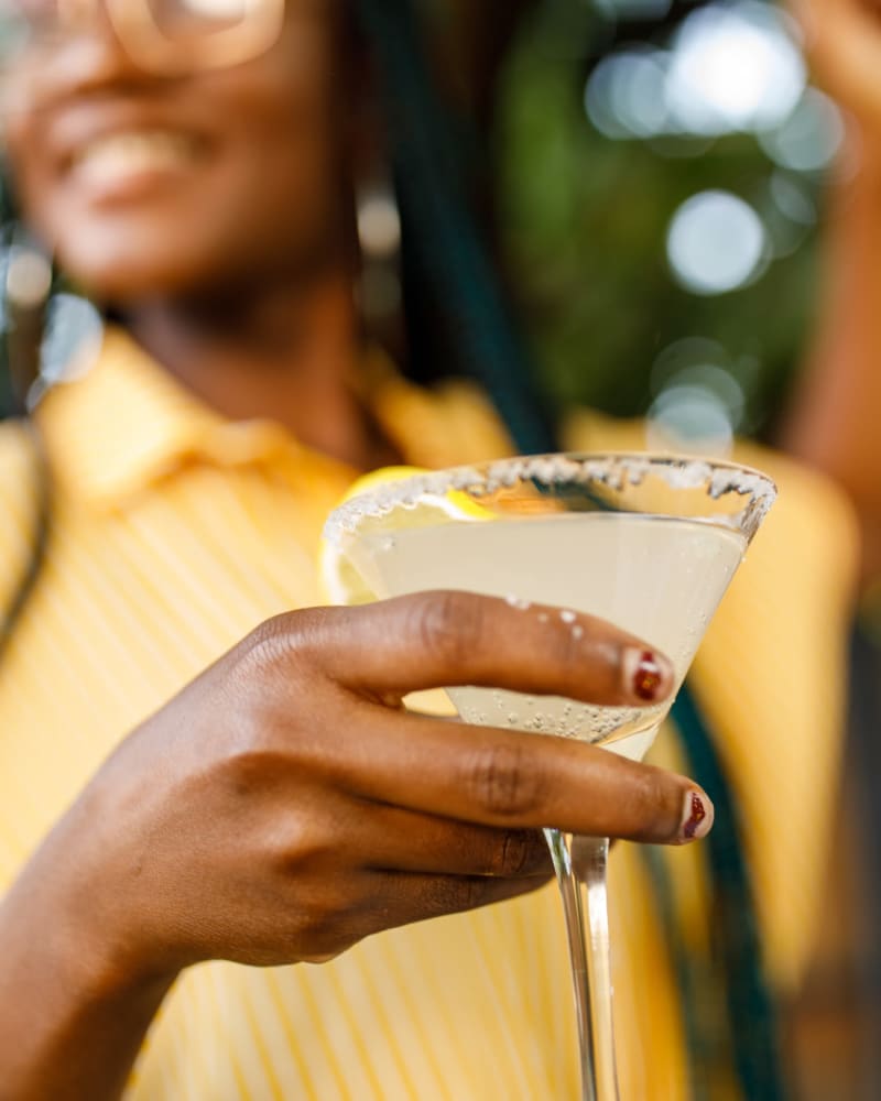 Resident enjoying a cocktail on a sunny day at Parallel 36 at Jailette in Atlanta, Georgia