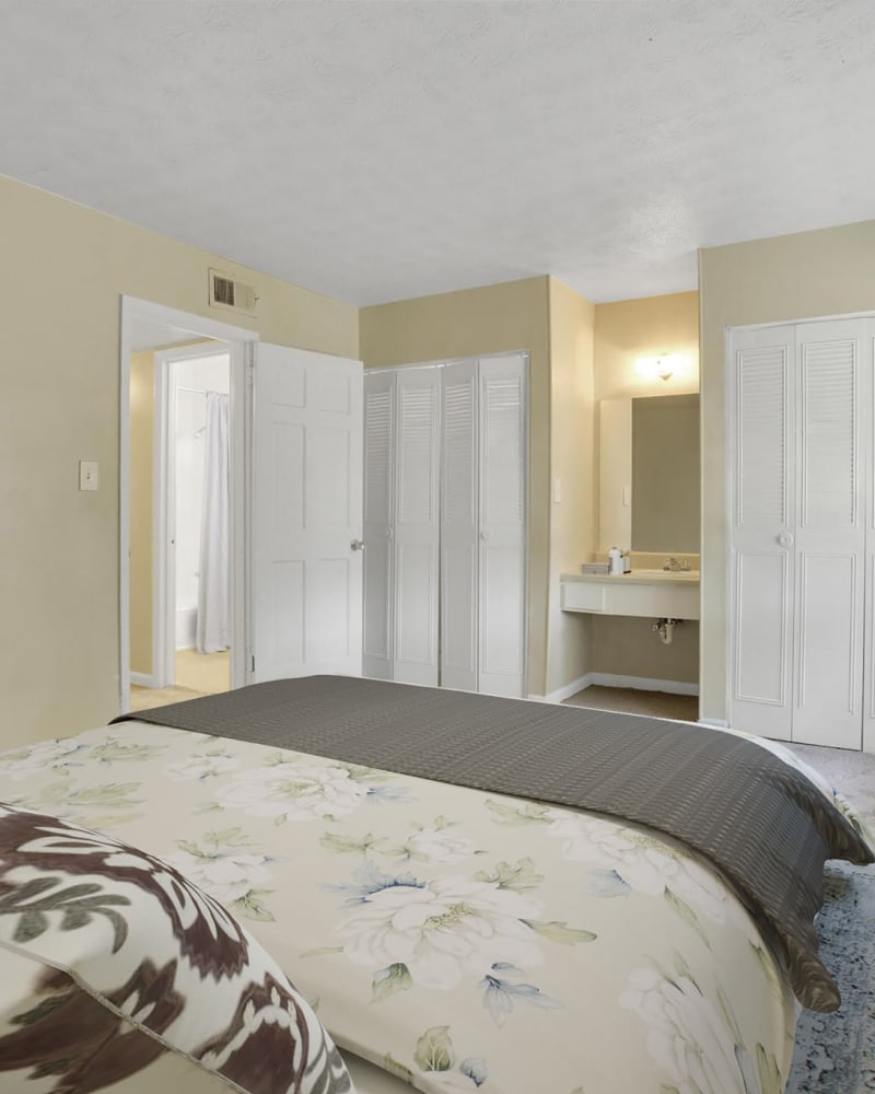A main bedroom with an attached bathroom at Rivers Edge Apartments in Jonesboro, Georgia