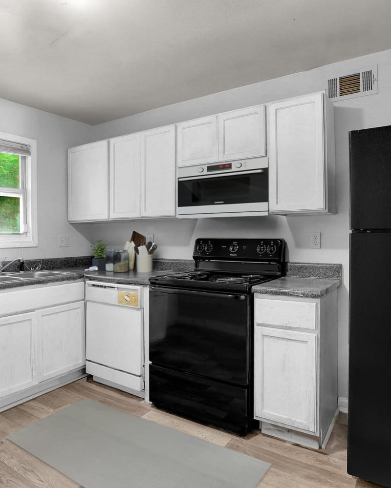 Upgraded appliances and light wood cabinets in a kitchen at Stanton View Apartments in Atlanta, Georgia