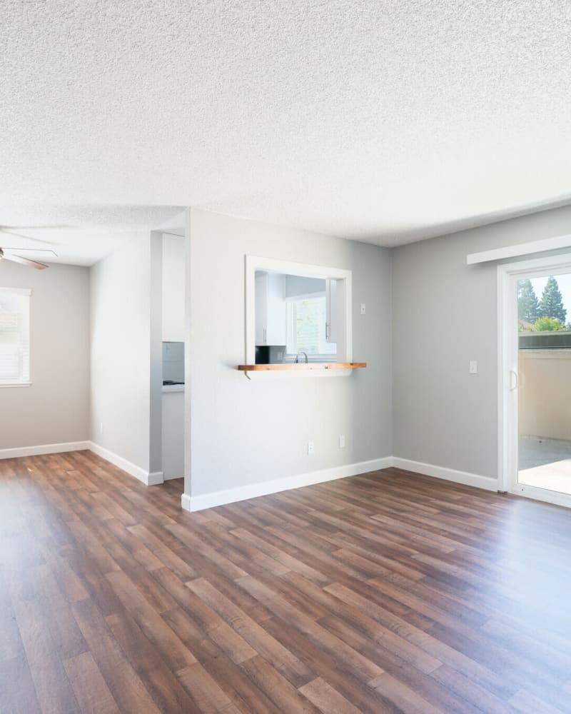 Living room with doors to balcony at Creekside Park Apartments in Napa, California