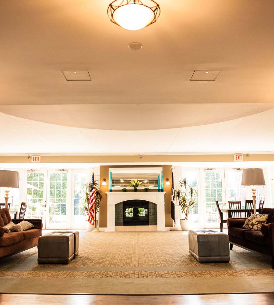 Community room with fire place at Atlas Point at Prestonwood in Carrollton, TX