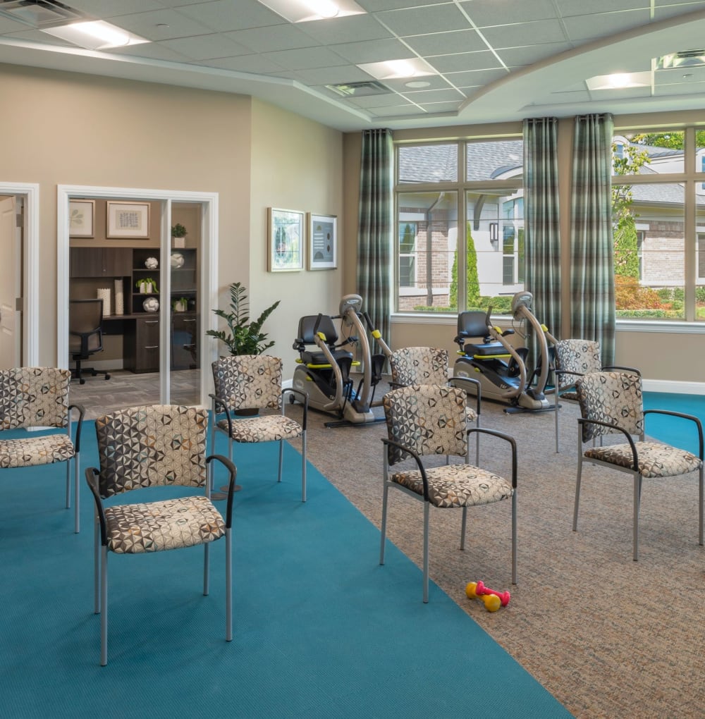Fitness area with chair seating and weights at Blossom Springs in Oakland Twp, Michigan