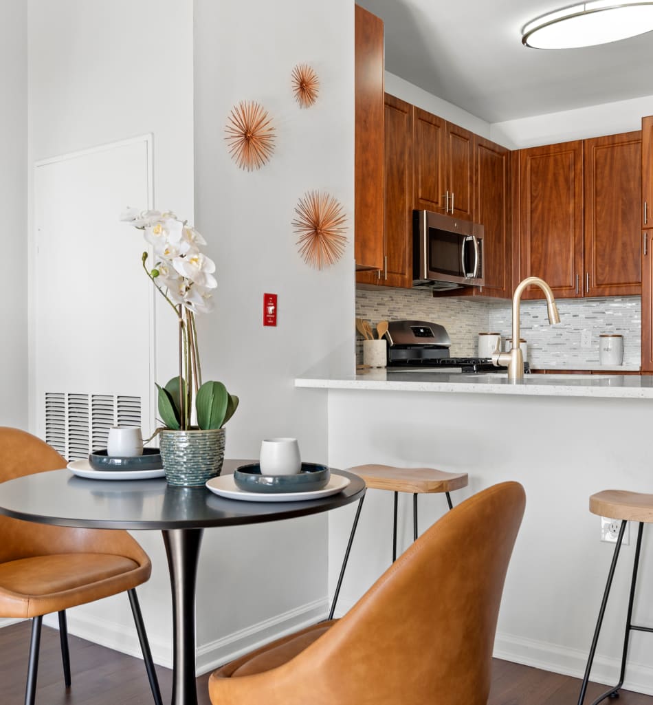 Open-concept living area with a cute blue area rug at Sofi Lyndhurst in Lyndhurst, New Jersey