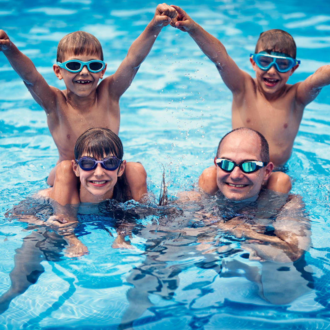Family enjoying the refreshing swimming pool at Avilla Buffalo Run in Commerce City, Colorado