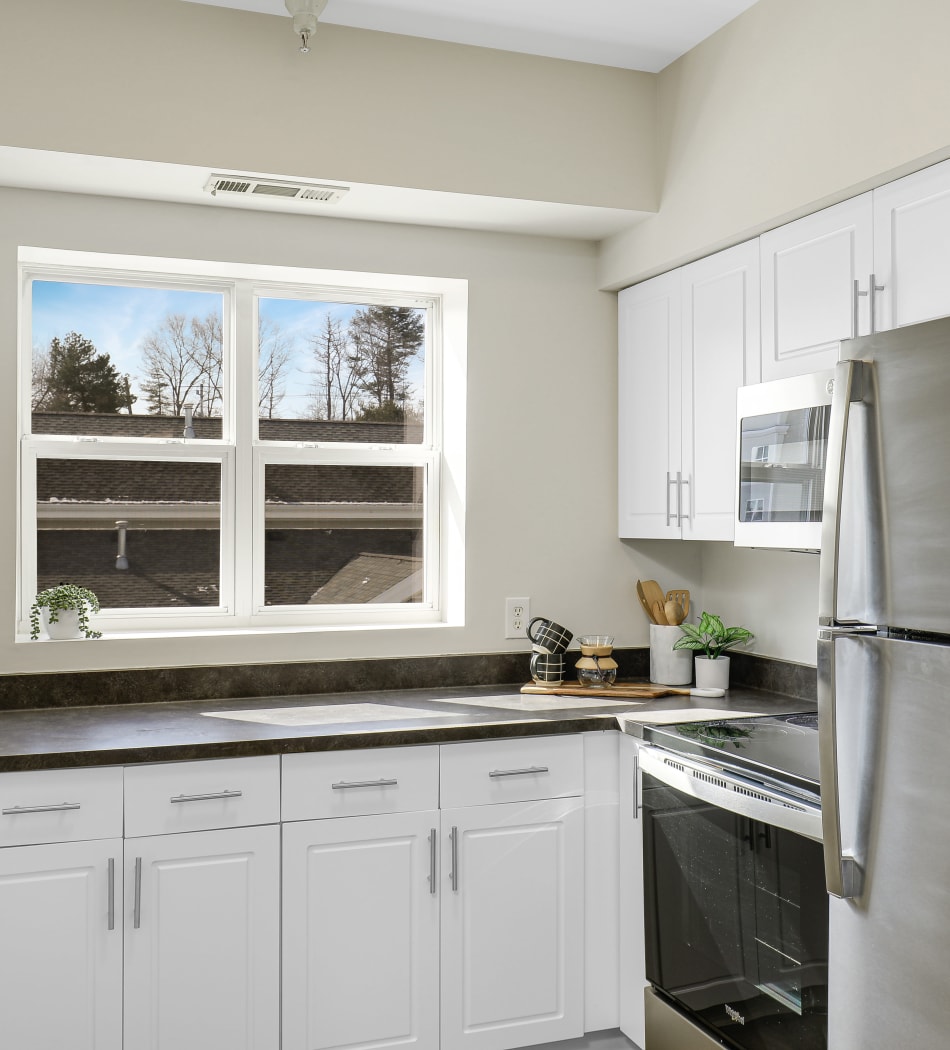 Bright kitchen with modern stainless steel appliances at Sofi Danvers in Danvers, Massachusetts