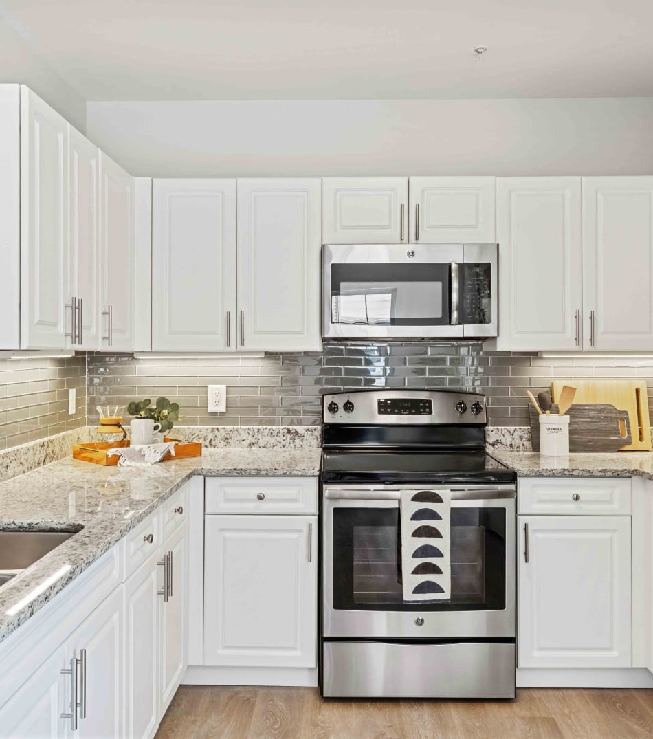 Modern kitchen with sleek, stainless-steel appliances in a model home at Sofi at Salem Station in Salem, Massachusetts