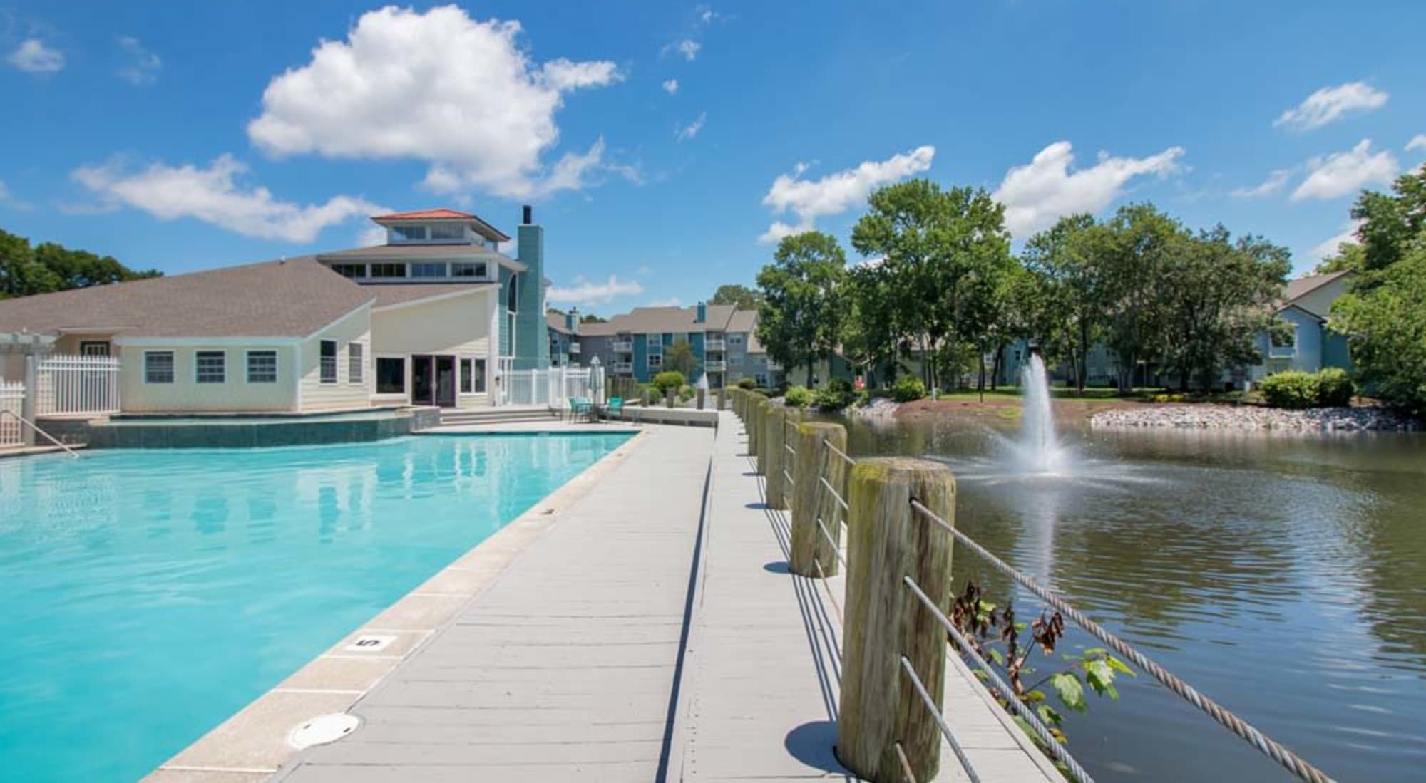 Swimming pool with a view of the pond at Runaway Bay Apartments in Virginia Beach, Virginia