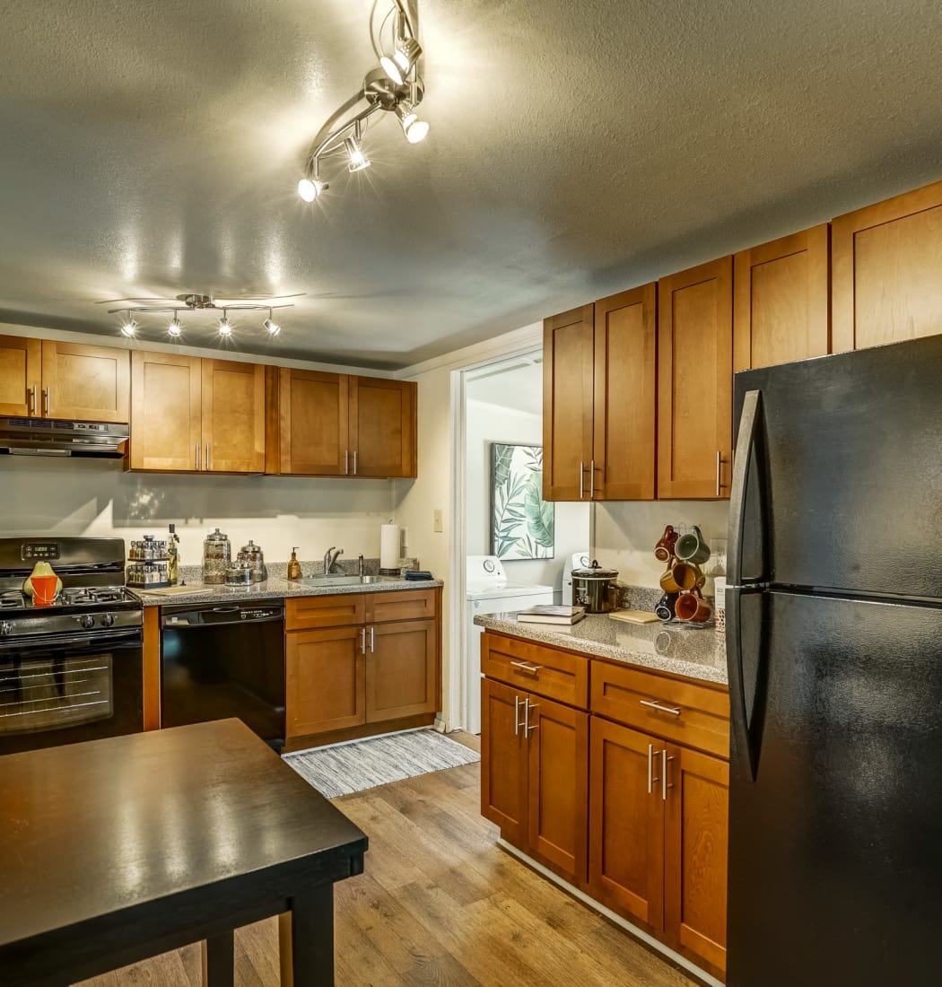 Bright and modern kitchen with hardwood floors and custom lighting in model townhome at Avalon Townhomes in Hampton, VA