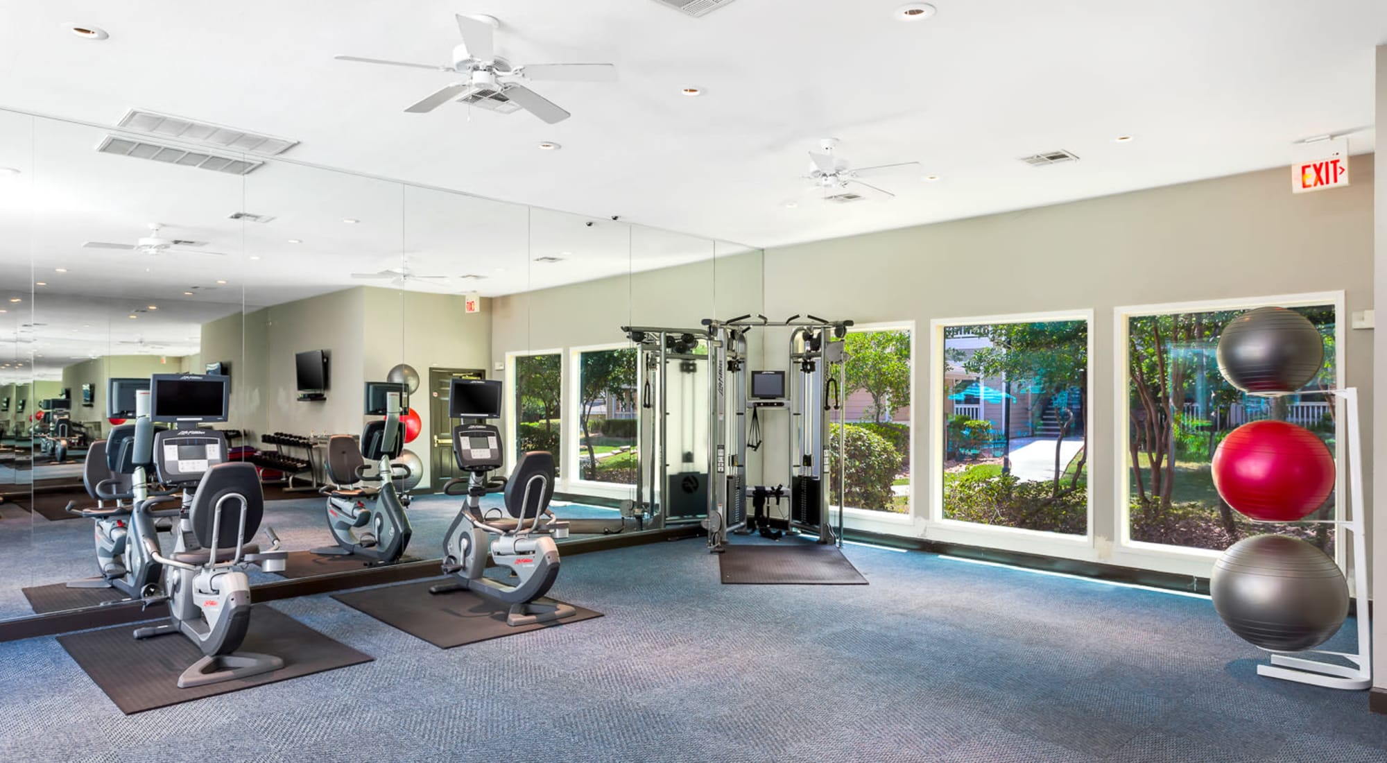 Fitness Center overlooking swimming pool at The Lodge at Shavano Park