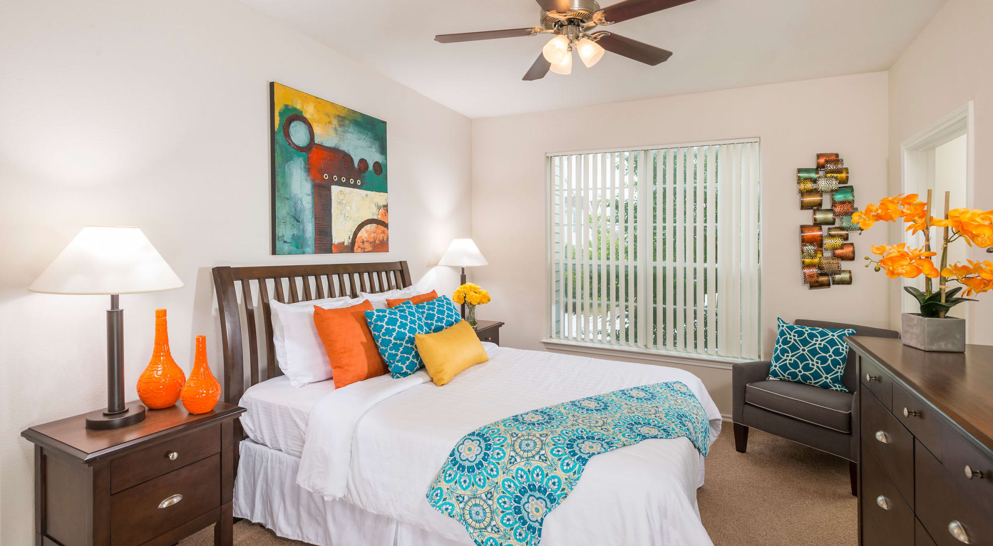 Cozy bedroom with ceiling fan at The Lodge at Westover Hills in San Antonio, Texas