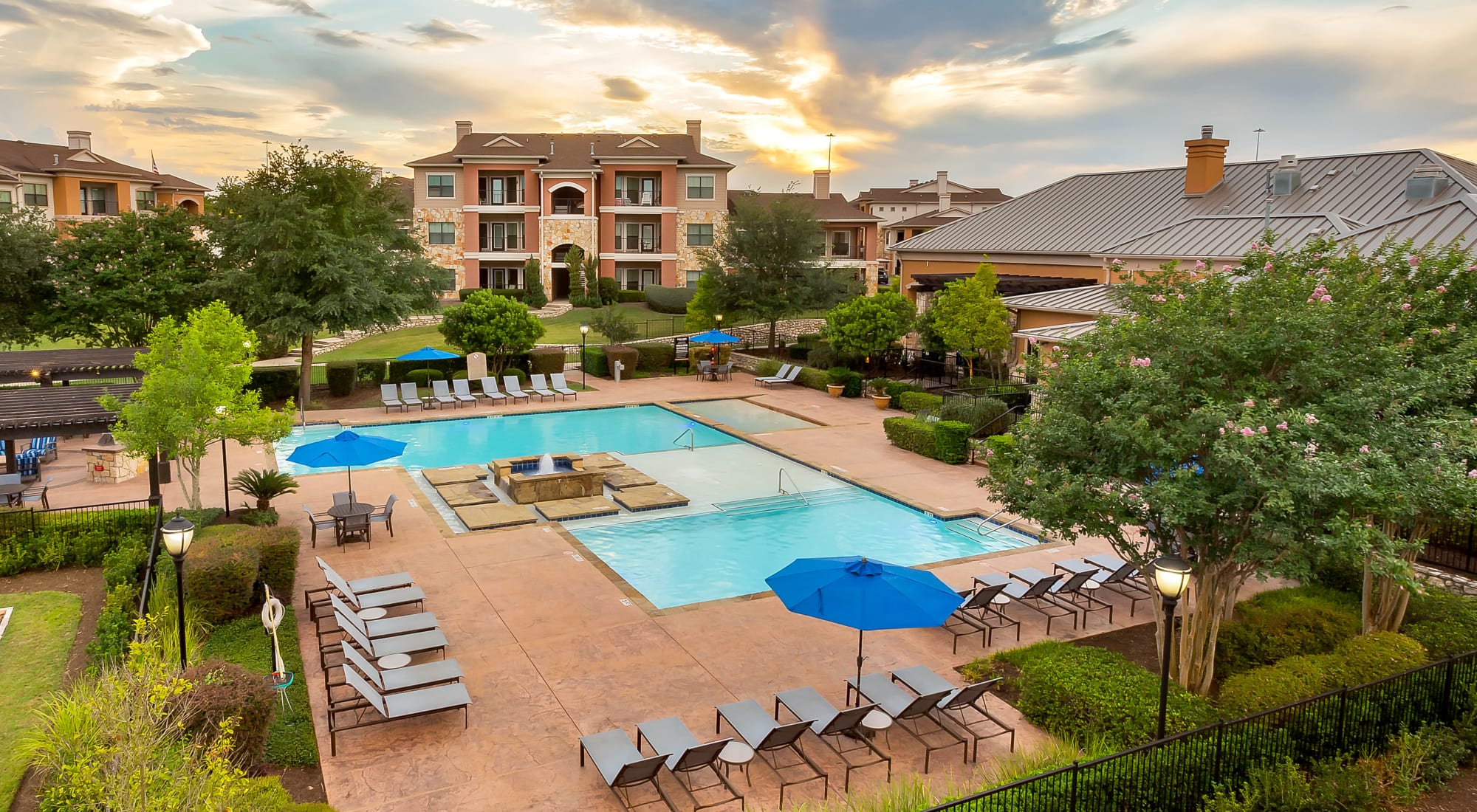 Lounge chairs around the pool at Onion Creek Luxury Apartments in Austin, Texas