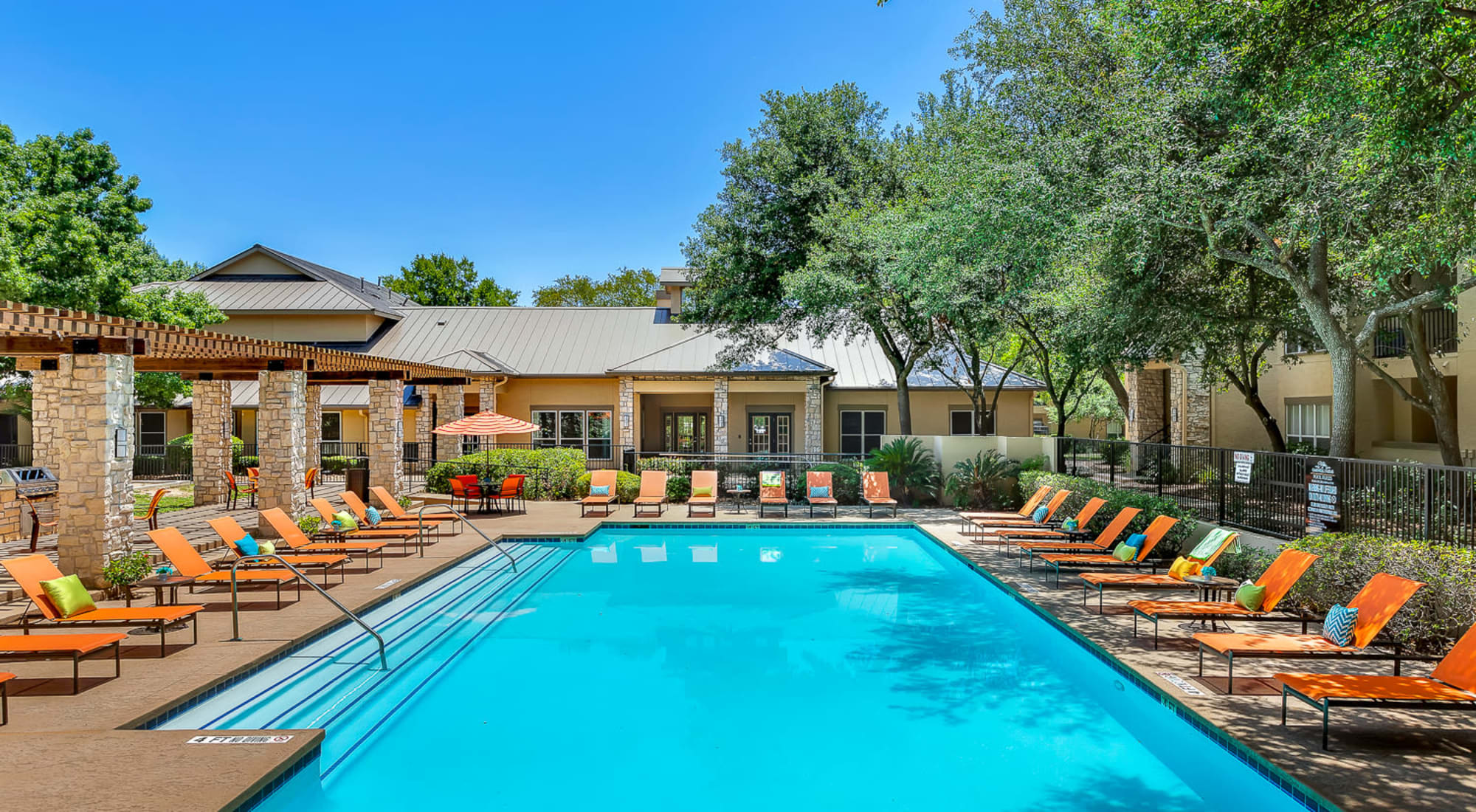 Swimming pool with lounge chairs at Villas at Oakwell Farms