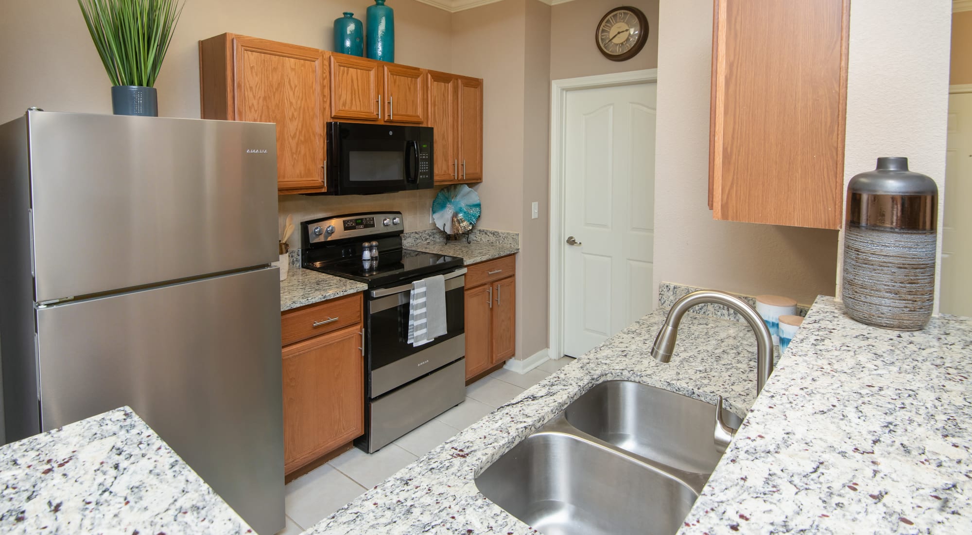 Kitchen with sink and refrigerator at Estancia at Ridgeview Ranch