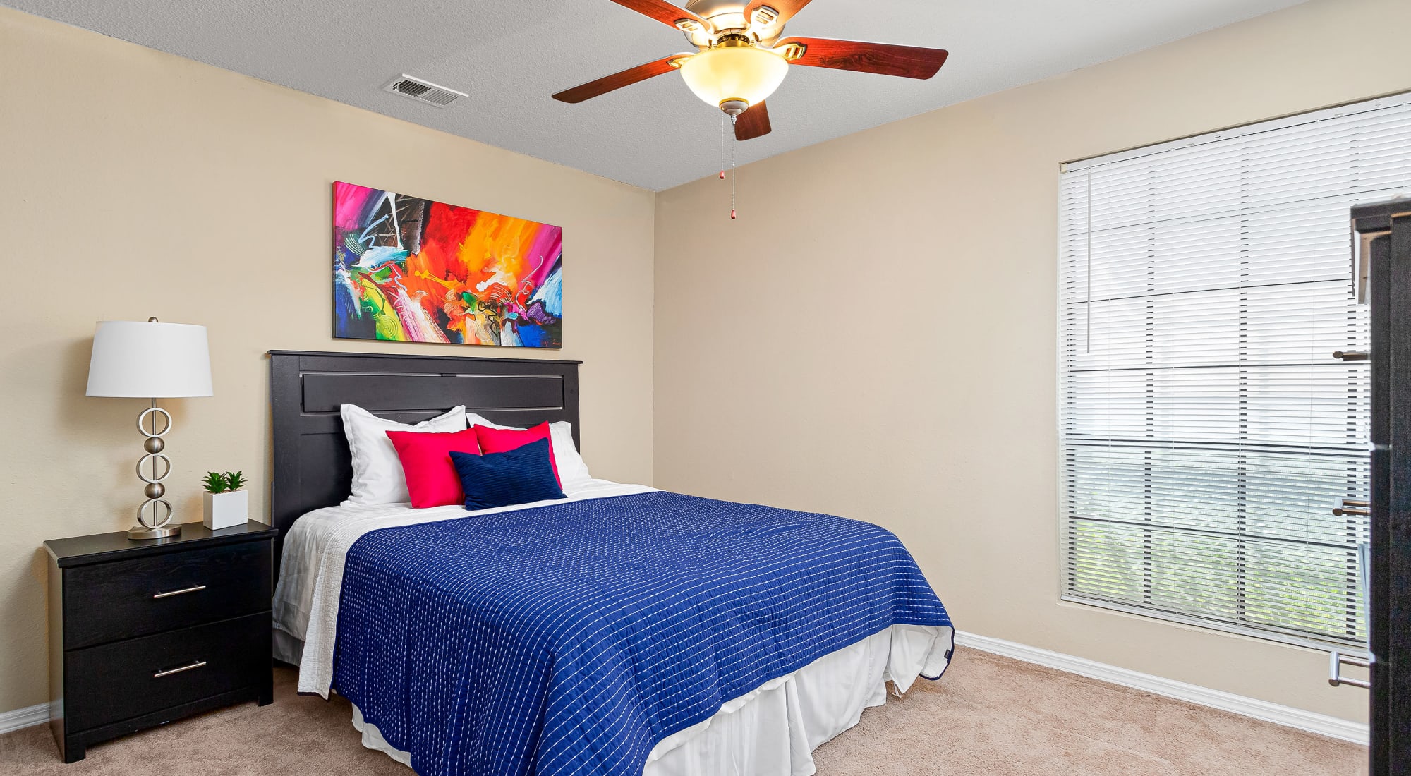Bedroom with large window at Stoneybrook Apartments and Townhomes
