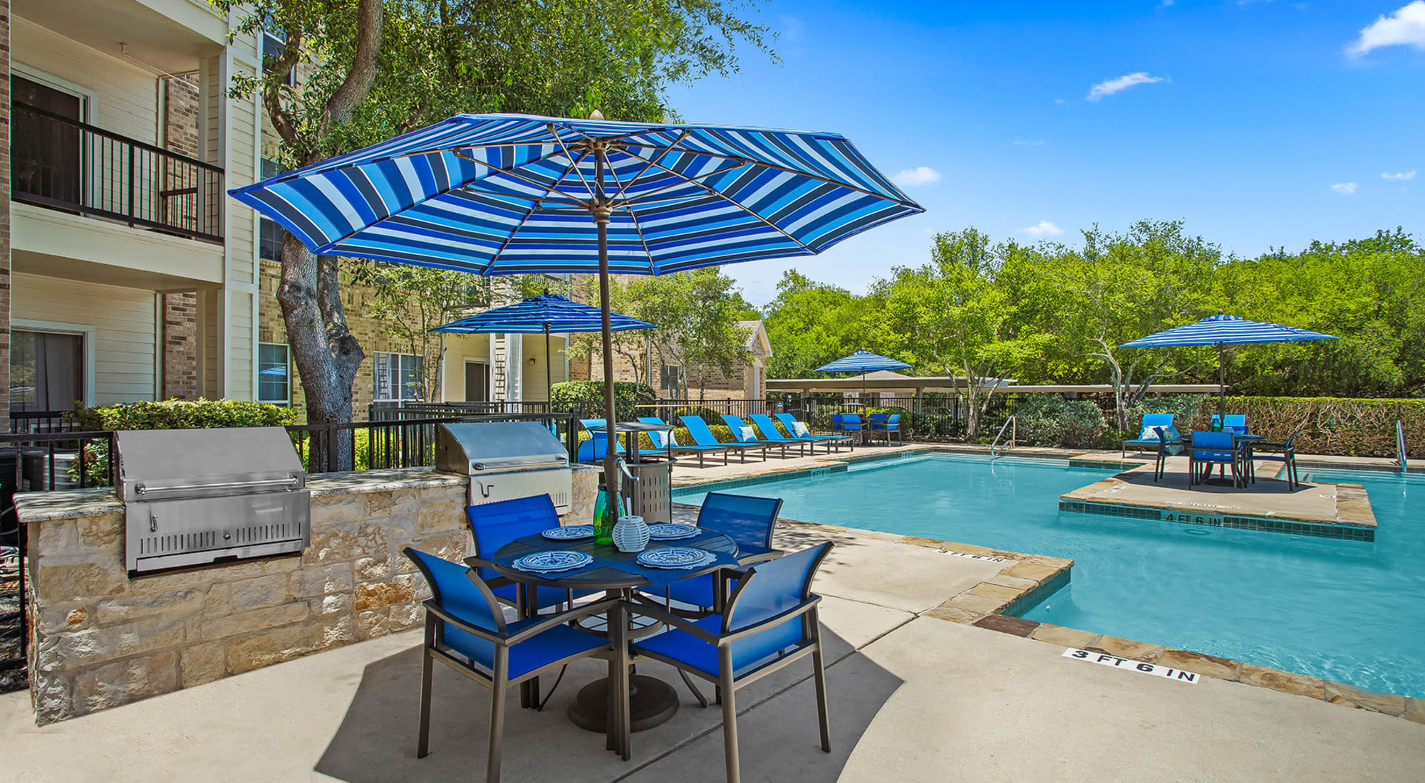 Swimming pool with outside seating at Stoneybrook Apartments & Townhomes