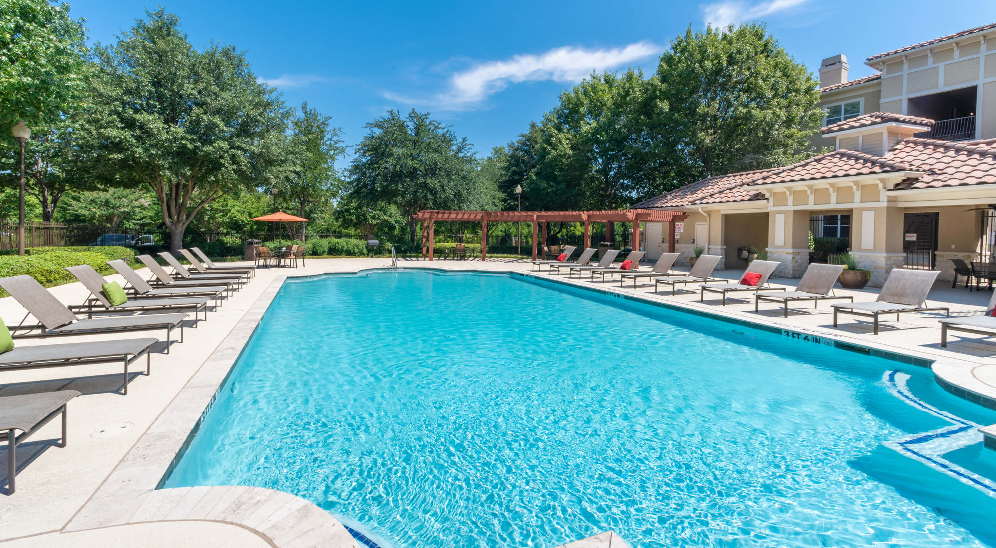 Pool with lounge chairs at Estancia at Ridgeview Ranch