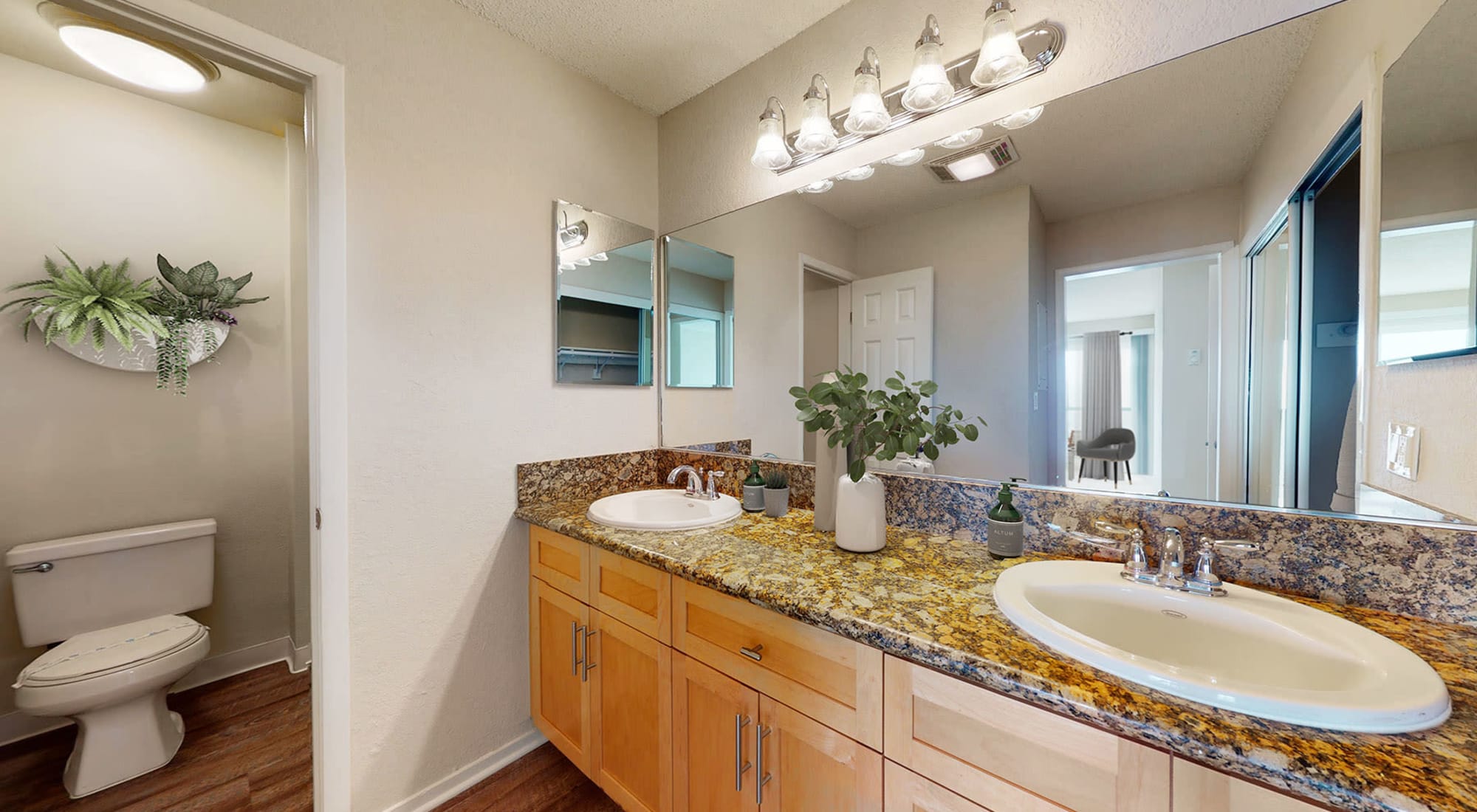 Bathroom with granite countertops and double sink in a spacious apartment home at The Tides at Marina Harbor in Marina del Rey, California