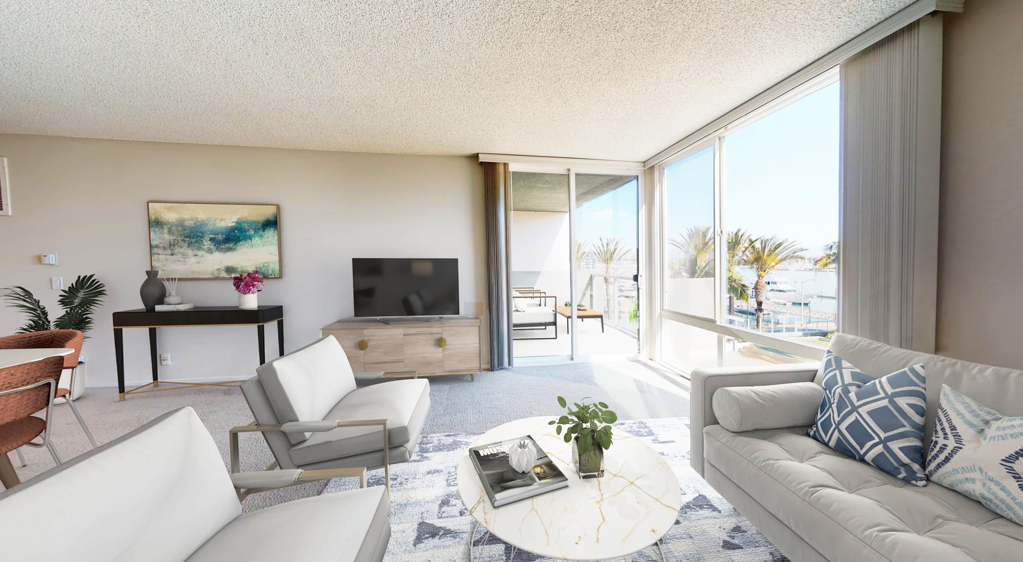 Living room with floor-to-ceiling windows and view of the marina at Waters Edge at Marina Harbor in Marina del Rey, California