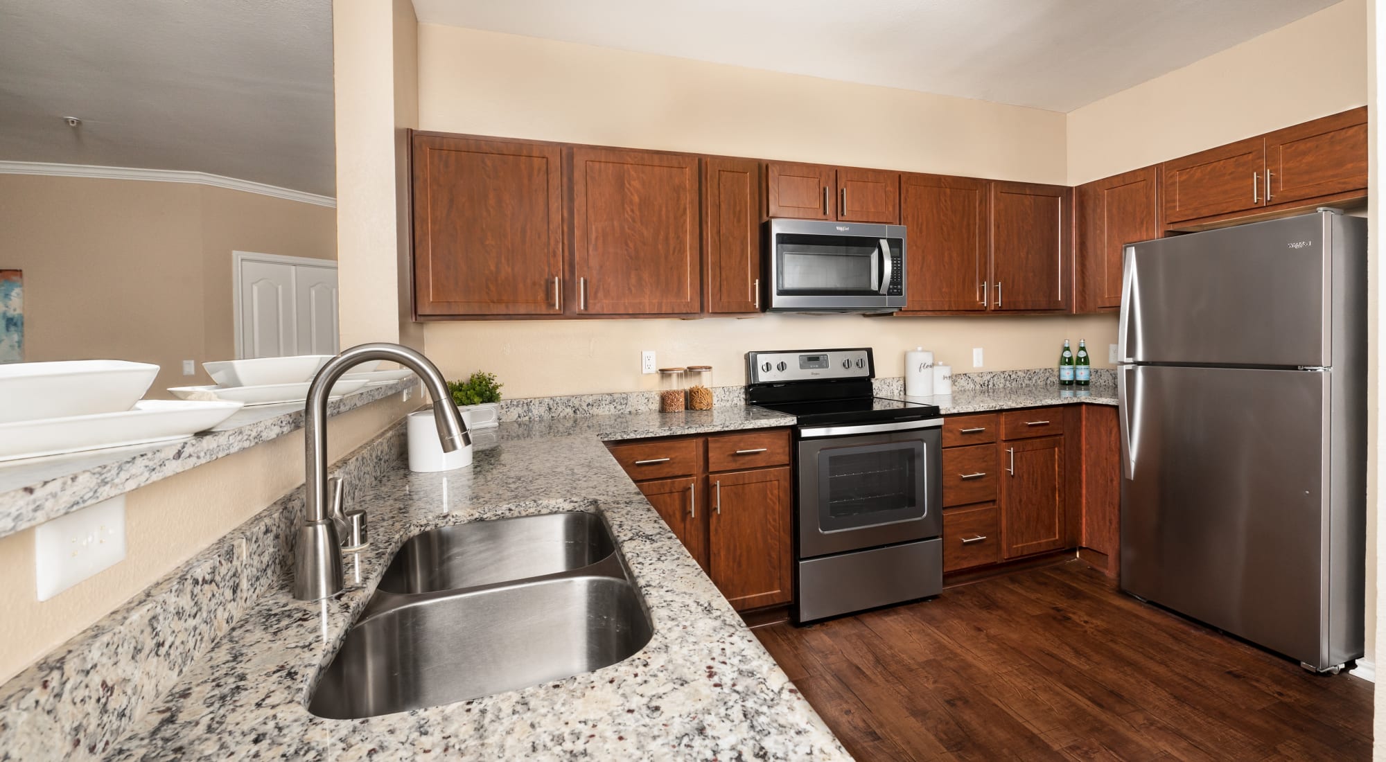 Kitchen with stainless steel appliances at El Lago Apartments