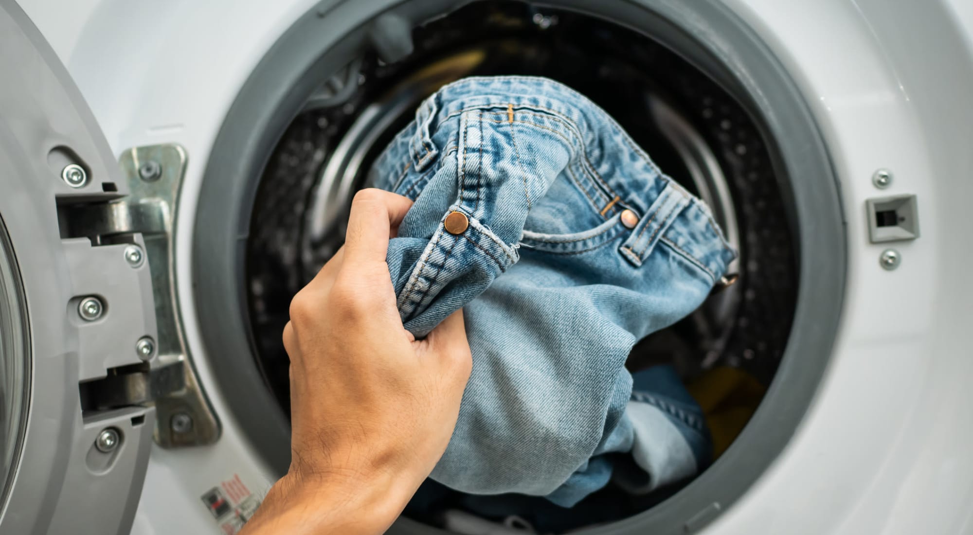 Resident using the laundry facility at Cheltenham Station in Philadelphia, Pennsylvania