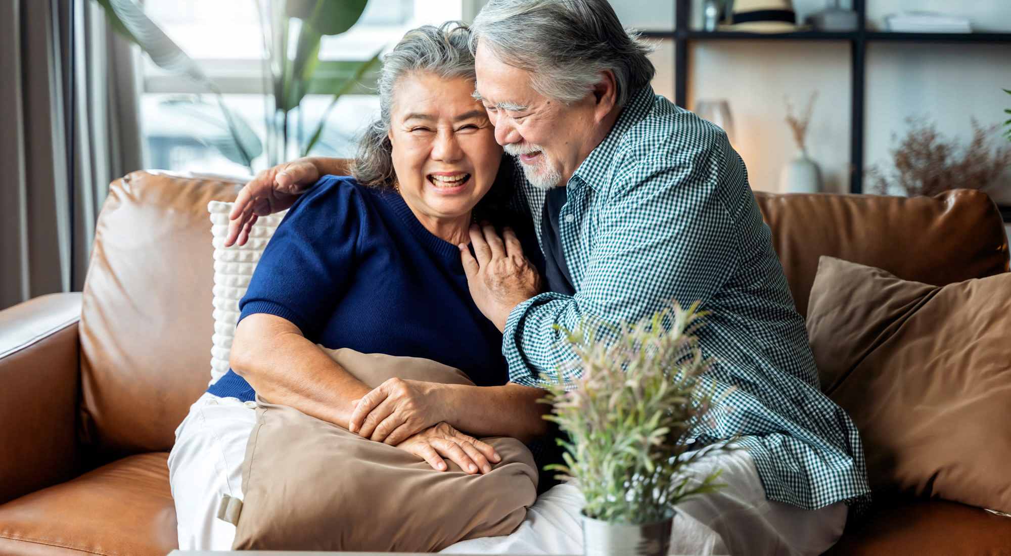 Loving couple on the couch at Nyer Urness House in Seattle, Washington