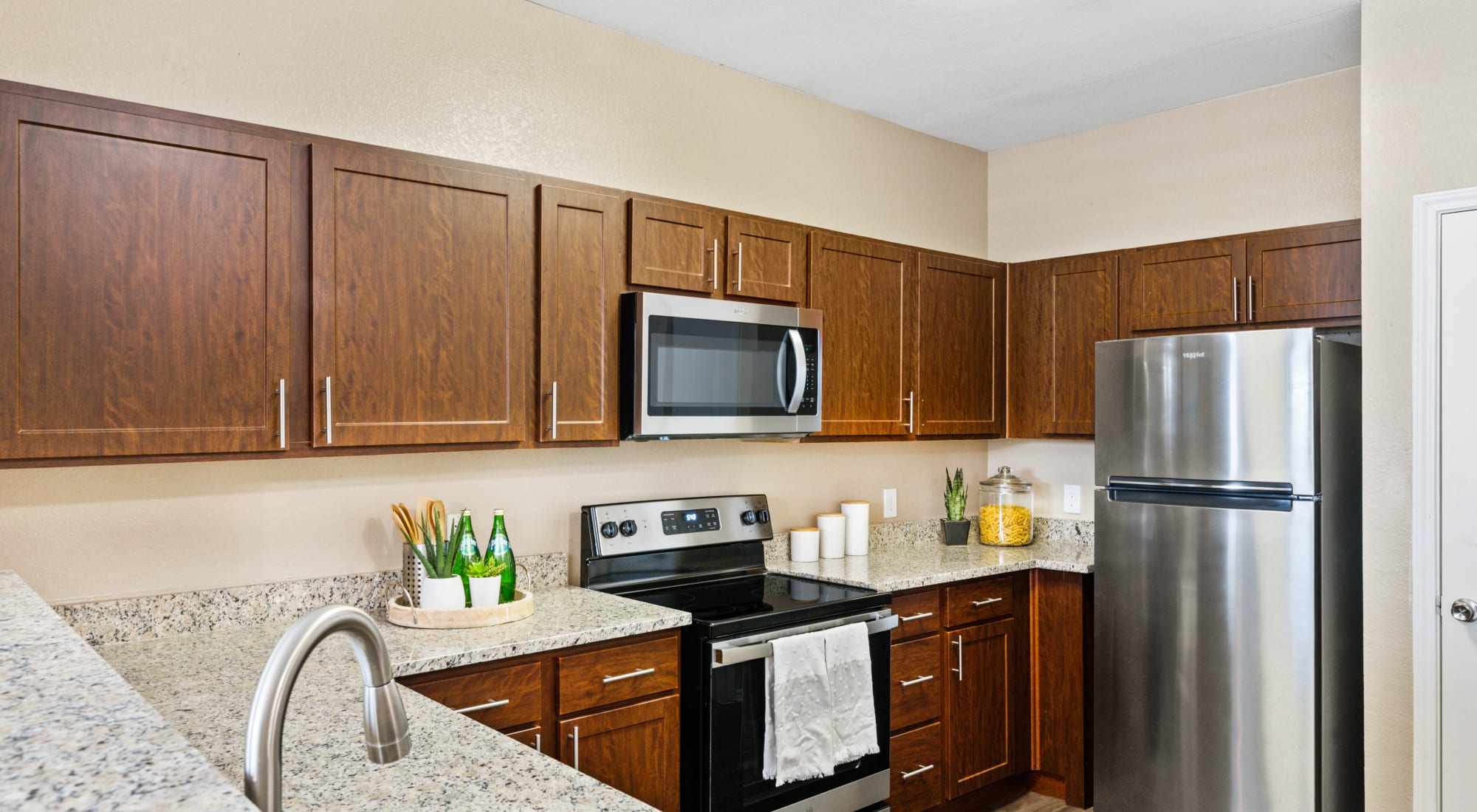 Kitchen with stainless steel appliances at El Lago Apartments