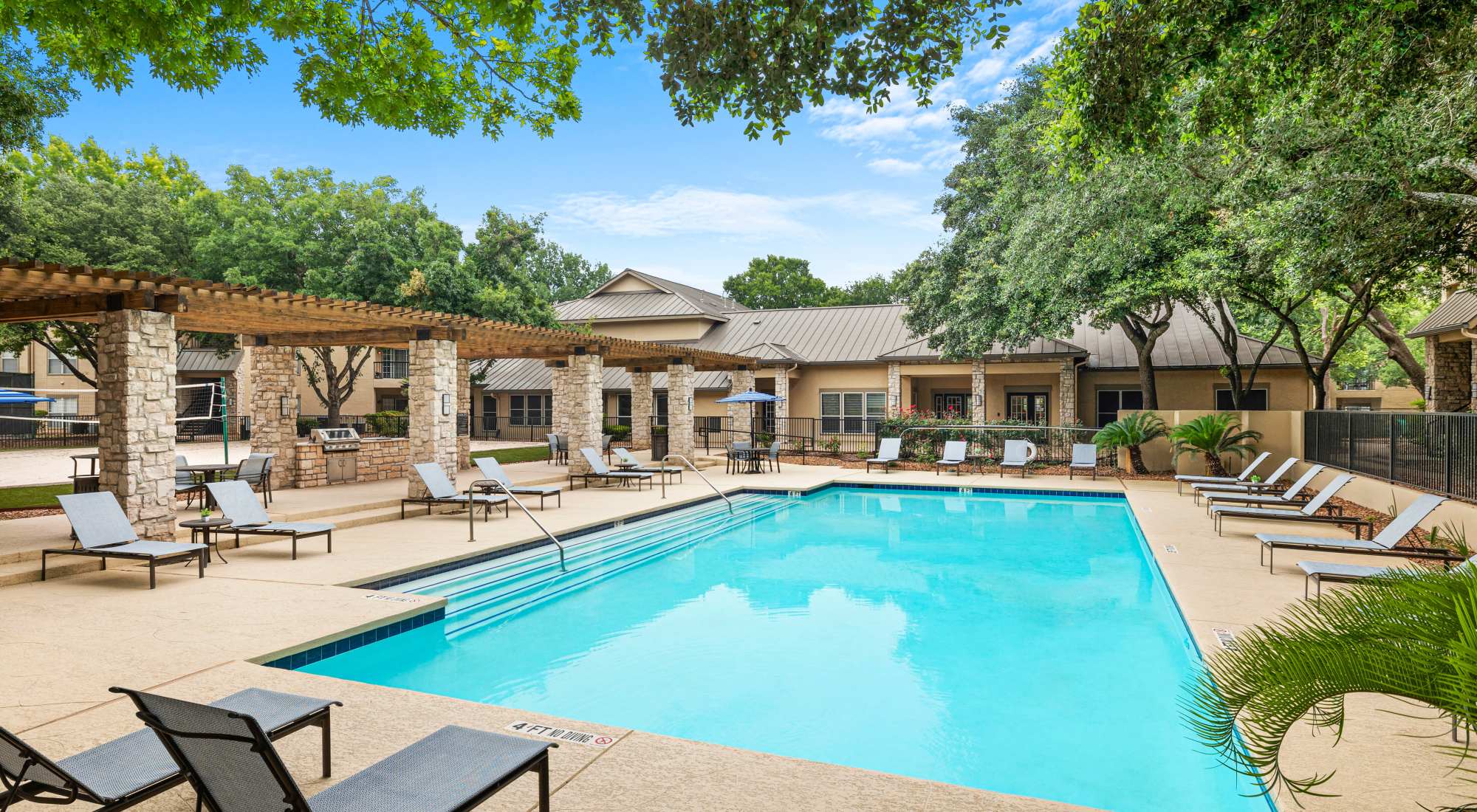 Swimming pool with lounge chairs at Villas at Oakwell Farms