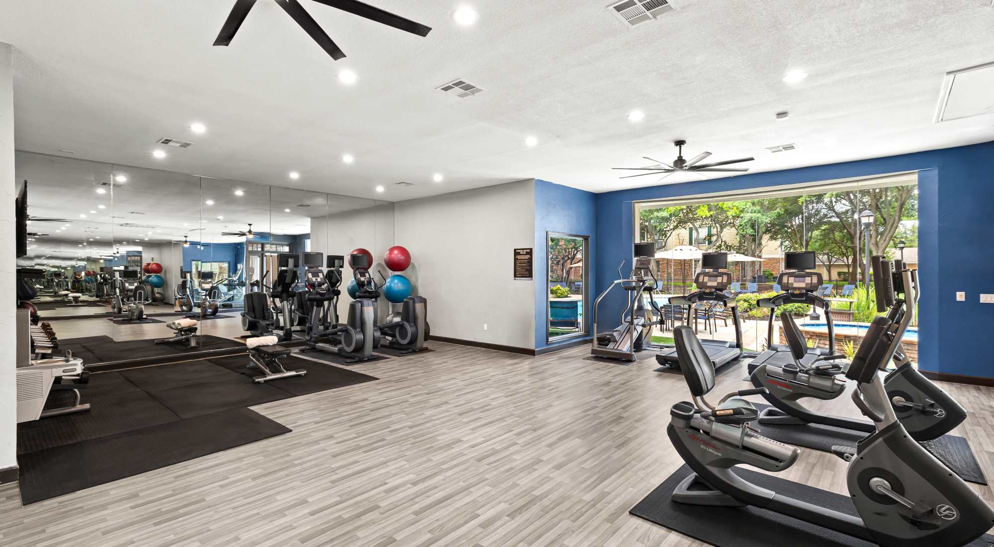 Fitness Center overlooking swimming pool at The Lodge at Shavano Park