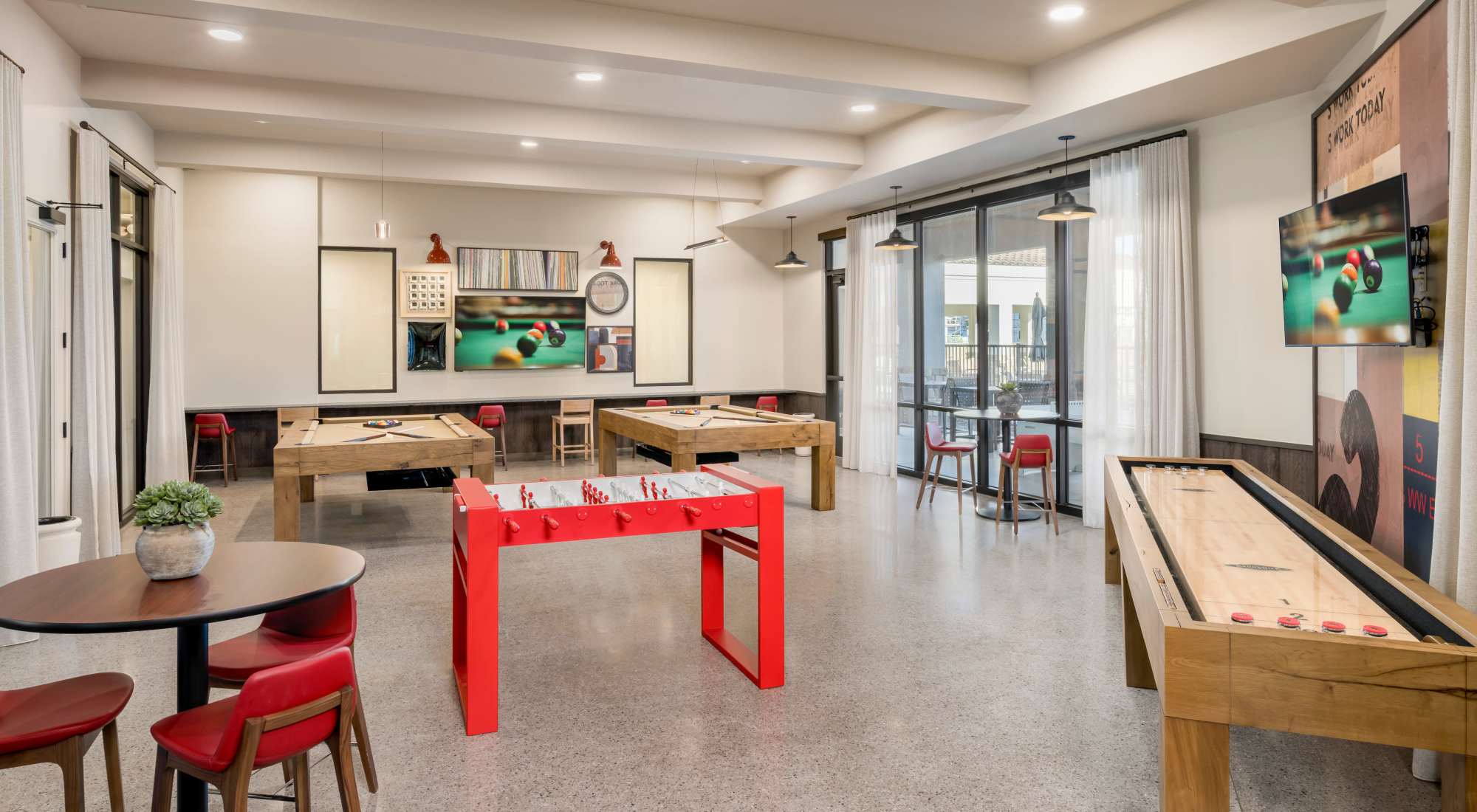 Game room with two pool tables, foosball and shuffleboard at Tuscany at Gabriella Pointe in Gilbert, Arizona
