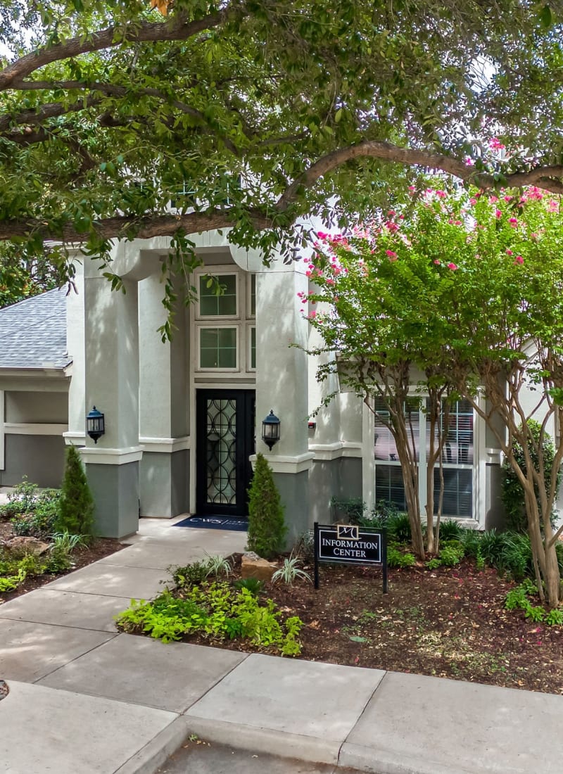 Unit entrance surrounded by green landscaping at Marquis at Stonegate in Fort Worth, Texas