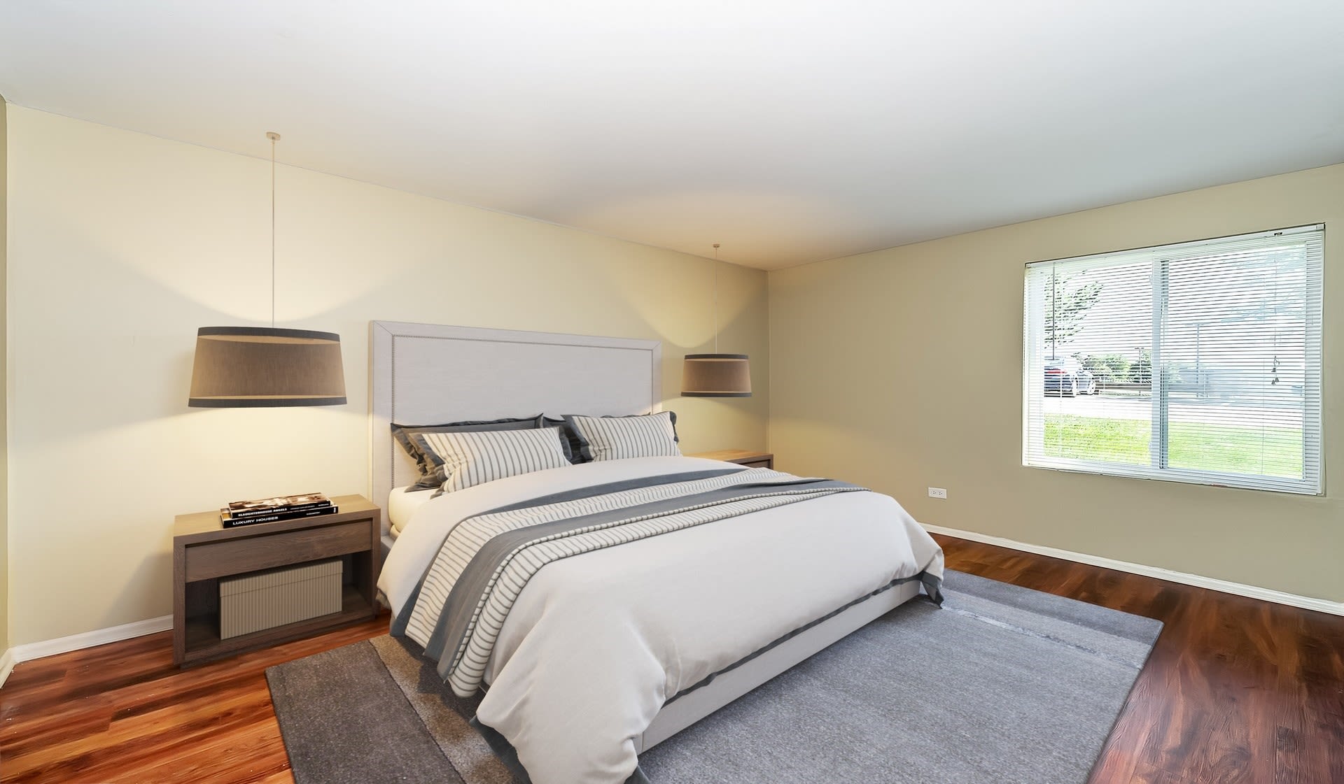 Large master bedroom with a window for natural lighting at Lakeside Apartments in Lisle, Illinois