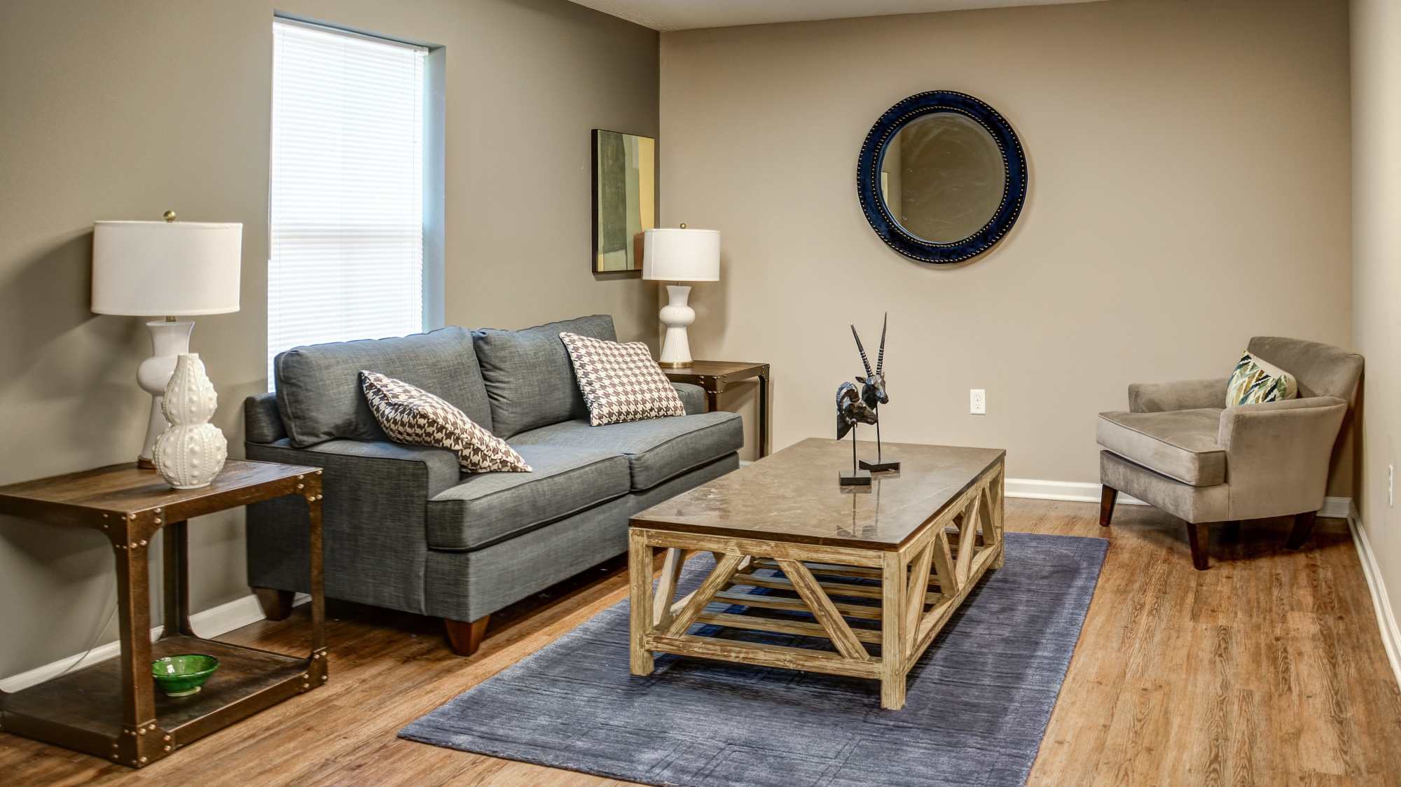 Community room with a couch and a window at The Banks At Berkley in Norfolk, Virginia